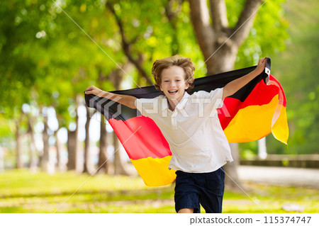 Child running with Germany flag. 115374747