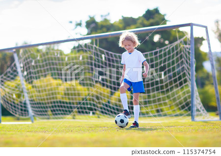 Kids play football. Child at soccer field. Kids play football. Child at soccer field. 115374754