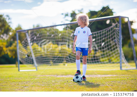 Kids play football. Child at soccer field. Kids play football. Child at soccer field. 115374758