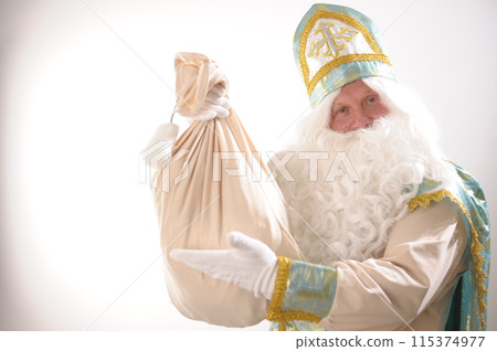 different positive emotions of St. Nicholas the Wonderworker who was founder of Santa Claus St. Nicholas is popularly called he is dressed in turquoise suit with gold with traditional religious cap different positive emotions of St. Nicholas the Wonderworker who was founder of Santa Claus St. Nicholas is popularly called he is dressed in turquoise suit with gold with traditional religious cap 115374977
