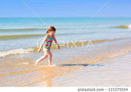 Kids playing on beach. Children play at sea. 115375034