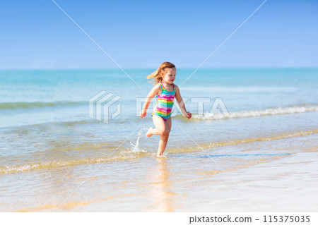 Kids playing on beach. Children play at sea. 115375035