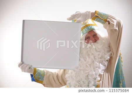 Fairy tale 12 months Nicholas the Wonderworker, Saint Nicholas Lights the stars with his fingers, throwing them in different directions, look at the camera and shows attention look founder of Santa Fairy tale 12 months Nicholas the Wonderworker, Saint Nicholas Lights the stars with his fingers, throwing them in different directions, look at the camera and shows attention look founder of Santa 115375084