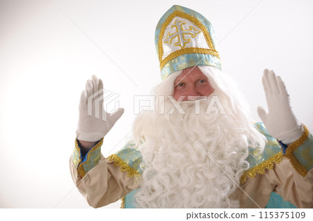 different positive emotions of St. Nicholas the Wonderworker who was founder of Santa Claus St. Nicholas is popularly called he is dressed in turquoise suit with gold with traditional religious cap 115375109