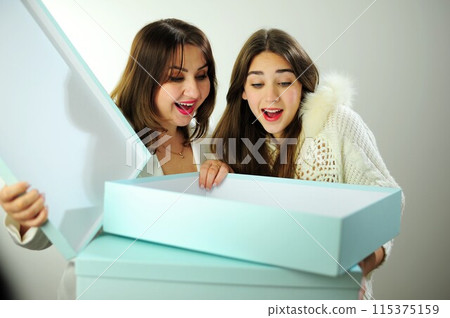 Online delivery empty boxes emotions facial expression greetings and gifts Mom and daughter look into box are surprised have fun and rejoice Woman aged 40 girl 16-18 positive emotions beautiful people Online delivery empty boxes emotions facial expression greetings and gifts Mom and daughter look into box are surprised have fun and rejoice Woman aged 40 girl 16-18 positive emotions beautiful people 115375159