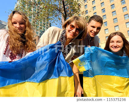 4 people of different ages in Ukrainian national clothes with the Ukrainian flag stand and look at each other They are waiting for the end of the war for peace Ukraine's victory over Russia's terror 4 people of different ages in Ukrainian national clothes with the Ukrainian flag stand and look at each other They are waiting for the end of the war for peace Ukraine's victory over Russia's terror 115375236