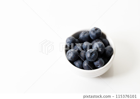 Ripe organic blueberries on white wooden table background. Selective focus. Ripe organic blueberries on white wooden table background. Selective focus. 115376101