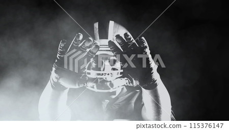 Image of smoke over american football player 115376147