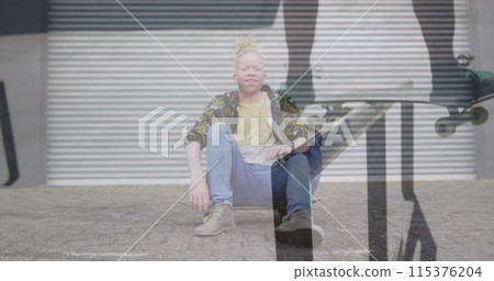 Image of man skateboarding over albino man sitting on skateboard Image of man skateboarding over albino man sitting on skateboard 115376204