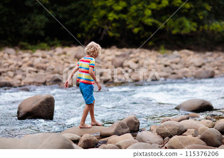 Child hiking in mountains. Kids at river shore. Child hiking in mountains. Kids at river shore. 115376206