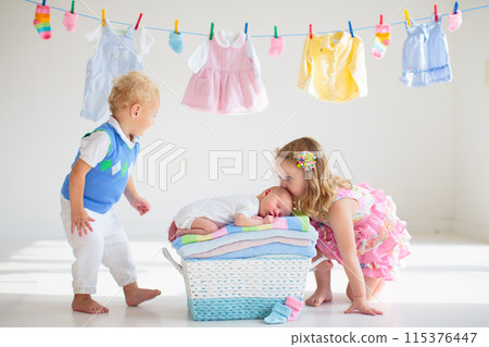 Baby boy on a pile of towels at laundry line Baby boy on a pile of towels at laundry line 115376447