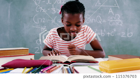 Image of mathematical equations floating over schoolchild sitting at desk and reading a book Image of mathematical equations floating over schoolchild sitting at desk and reading a book 115376703