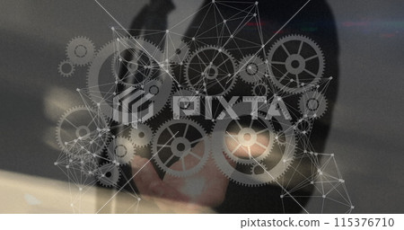 Image of network of connections with cogs over caucasian businessman 115376710