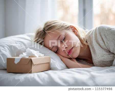 Portrait of a sick or tired child girl lying in a white bed at home. Sleeping baby 115377498