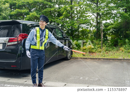 Security guard directing people in the parking lot Security guard directing people in the parking lot 115378897