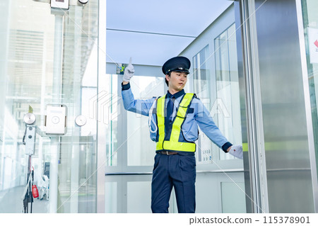 Security guard inspecting the elevator Security guard inspecting the elevator 115378901