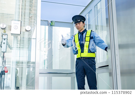 Security guard inspecting the elevator 115378902