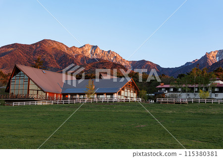 View of the Yatsugatake mountain range bathed in the morning sun from the Kiyosato Plateau in the early morning, spring 115380381