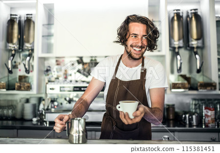 Handsome barista working in coffee shop, preparing coffee. University student working part-time in cafe. Handsome barista working in coffee shop, preparing coffee. University student working part-time in cafe. 115381451