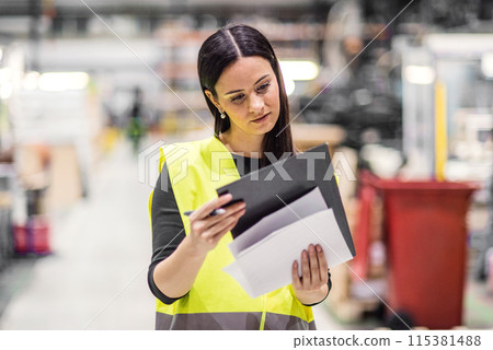 Female warehouse worker reading product order, order picking. Warehouse manager checking delivery, stock, inspecting products for the shipment. Female warehouse worker reading product order, order picking. Warehouse manager checking delivery, stock, inspecting products for the shipment. 115381488