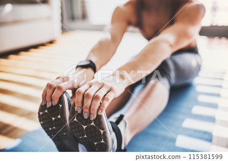 Beautiful redhead woman's home fitness routine. Home workout on gym mt in living room, sporty woman wearing sportswear. 115381599