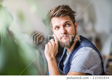 Young businessman working on new project with colleagues in a startup company office. Working in co-working space. 115381654