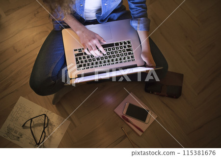 Beautiful university student is writing her thesis on a laptop at night, sitting at home at table, focusing on her research. Preparing for final exam, studying. Beautiful university student is writing her thesis on a laptop at night, sitting at home at table, focusing on her research. Preparing for final exam, studying. 115381676