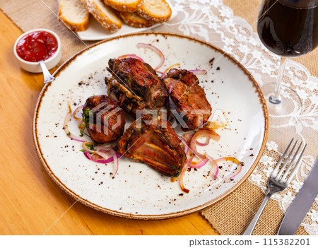 Lamb kebab served with onions on platter Lamb kebab served with onions on platter 115382201