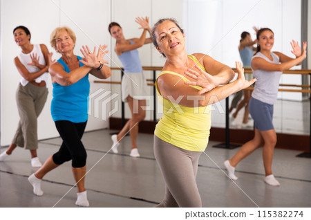 Active women enjoying training in dance studio, dance class for adults Active women enjoying training in dance studio, dance class for adults 115382274