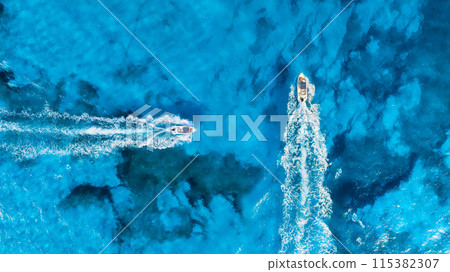 Vacation and leisure. Aerial view on fast boats on blue sea at sunny day.  115382307