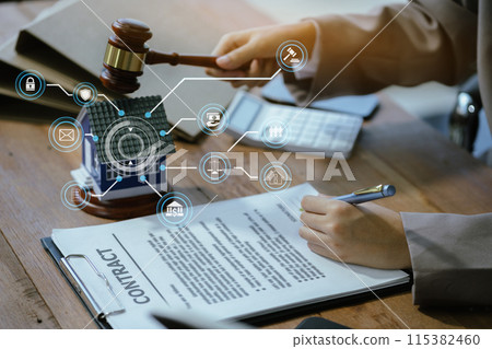 Justice and law concept. Real Estate Law in a courtroom the gavel, working with digital tablet computer on wood table in sun light. Justice and law concept. Real Estate Law in a courtroom the gavel, working with digital tablet computer on wood table in sun light. 115382460