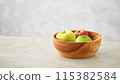 Apples and the shadow of sunlight filtering through the trees 115382584