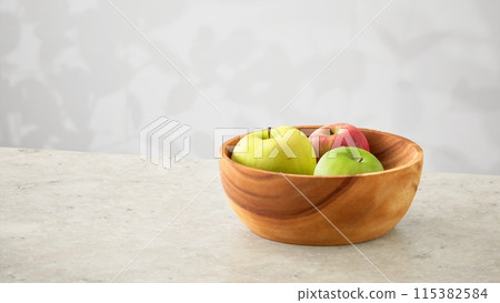Apples and the shadow of sunlight filtering through the trees 115382584