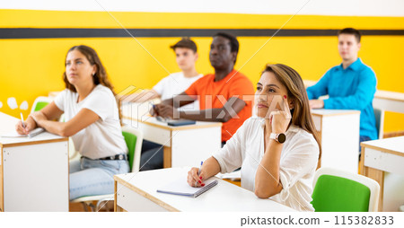 Latin woman studying in taxi driving school Latin woman studying in taxi driving school 115382833