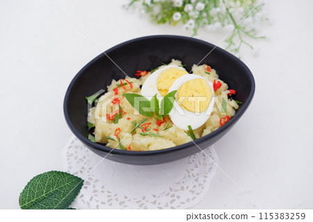 mashed potatoes with eggs as a background 115383259