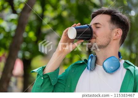 Happy man enjoying morning coffee hot drink and smiling relaxing, taking a break on city street 115383467