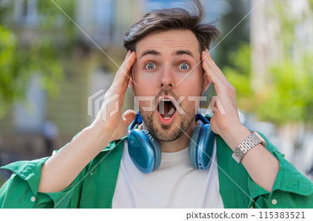 Amazed man looking surprised at camera with big open eyes, shocked by sudden victory good news Amazed man looking surprised at camera with big open eyes, shocked by sudden victory good news 115383521