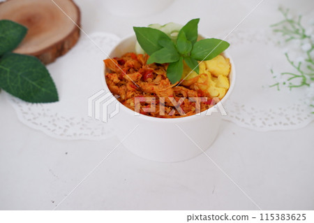 rice with sliced spicy chicken and vegetables as a background rice with sliced spicy chicken and vegetables as a background 115383625