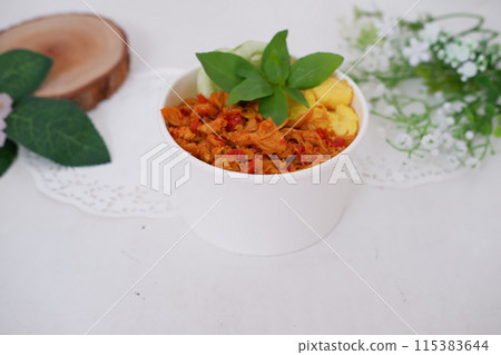 rice with sliced spicy chicken and vegetables as a background rice with sliced spicy chicken and vegetables as a background 115383644