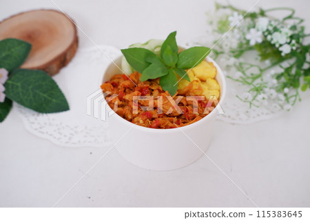 rice with sliced spicy chicken and vegetables as a background rice with sliced spicy chicken and vegetables as a background 115383645