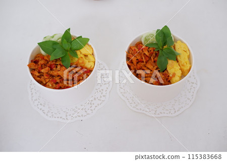 rice with sliced spicy chicken and vegetables as a background rice with sliced spicy chicken and vegetables as a background 115383668