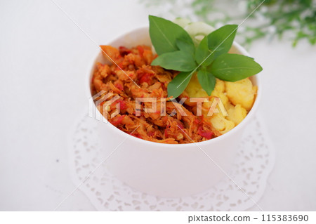 rice with sliced spicy chicken and vegetables as a background rice with sliced spicy chicken and vegetables as a background 115383690