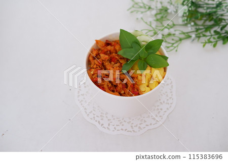 rice with sliced spicy chicken and vegetables as a background rice with sliced spicy chicken and vegetables as a background 115383696