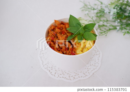 rice with sliced spicy chicken and vegetables as a background rice with sliced spicy chicken and vegetables as a background 115383701