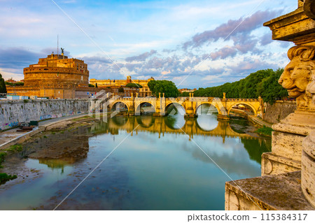 A view of Castel SantAngelo and Ponte SantAngelo, originally the Aelian Bridge or Pons Aelius, in Rome, Italy. The iconic castle and bridge are reflected in the still waters of the Tiber River. A view of Castel SantAngelo and Ponte SantAngelo, originally the Aelian Bridge or Pons Aelius, in Rome, Italy. The iconic castle and bridge are reflected in the still waters of the Tiber River. 115384317