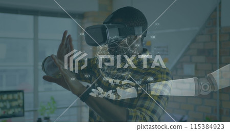 Image of globe of connections over robot's arm and man wearing vr headset in background Image of globe of connections over robot's arm and man wearing vr headset in background 115384923