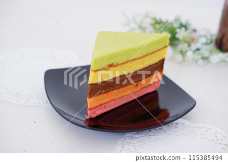 delicious rainbow cake slice as a background delicious rainbow cake slice as a background 115385494
