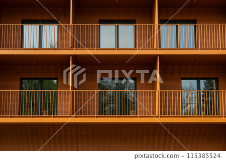 Apartment building with bright facades. Modern minimalist architecture with balcony. Balcony and windows in a row on the facade of the modern urban apartment building front view, Apartment building with bright facades. Modern minimalist architecture with balcony. Balcony and windows in a row on the facade of the modern urban apartment building front view, 115385524