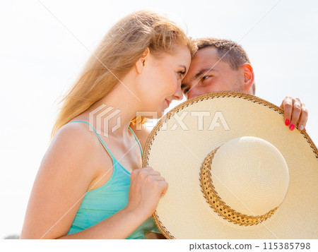 Man and woman sitting together outside 115385798