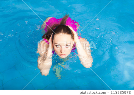 Woman having fun in swimming pool Woman having fun in swimming pool 115385978